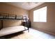 Bedroom showcasing a bunk bed, neutral walls, tile floors, and a bright window at 10657 Blue Nile Ct, Las Vegas, NV 89144
