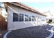 Charming home exterior featuring a tan facade, rock landscaping, and multi-pane windows at 10657 Blue Nile Ct, Las Vegas, NV 89144