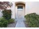 Inviting front entrance featuring double doors, a transom window, and mature landscaping at 10657 Blue Nile Ct, Las Vegas, NV 89144