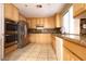 Bright kitchen features stainless appliances, granite countertops, tile floor and beautiful wood cabinets at 10657 Blue Nile Ct, Las Vegas, NV 89144