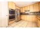 Bright kitchen features stainless appliances, granite countertops, tile floor and beautiful wood cabinets at 10657 Blue Nile Ct, Las Vegas, NV 89144
