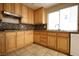 Bright kitchen features granite countertops, tile floor and light wood cabinets at 10657 Blue Nile Ct, Las Vegas, NV 89144