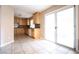 Bright eat-in kitchen features tile floor, wood cabinets, modern appliances, granite countertops and sliding glass doors at 10657 Blue Nile Ct, Las Vegas, NV 89144