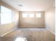 A spacious room featuring neutral carpet and many windows providing natural light at 10657 Blue Nile Ct, Las Vegas, NV 89144