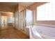 Spacious main bathroom with soaking tub, glass enclosed shower and separate vanity at 10657 Blue Nile Ct, Las Vegas, NV 89144
