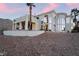 Exterior view of home with mountain views, arches, and lush desert landscaping at 117 Milton Ct, Boulder City, NV 89005