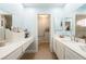 Bright bathroom features a double sink vanity, accessible toilet room, and soft blue paint at 1349 Foxglove Dr, Las Vegas, NV 89142