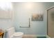 This bathroom has a handrail next to the toilet, shower, and beautiful painting on the wall at 1349 Foxglove Dr, Las Vegas, NV 89142