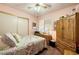 Cozy bedroom featuring a patterned quilt, natural light, and classic wooden furniture at 1349 Foxglove Dr, Las Vegas, NV 89142