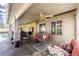 Comfortable covered patio with ceiling fan and lounge seating with patterned pillows, perfect for relaxing at 1349 Foxglove Dr, Las Vegas, NV 89142