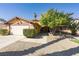 Inviting home with a well-kept lawn, mature trees, and attached garage, creating curb appeal at 1349 Foxglove Dr, Las Vegas, NV 89142