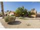 Well-maintained front yard featuring a lush green lawn, mature trees, and desert-friendly landscaping at 1349 Foxglove Dr, Las Vegas, NV 89142