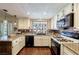 Bright kitchen with white cabinetry, stainless steel appliances, and a garden window at 1349 Foxglove Dr, Las Vegas, NV 89142