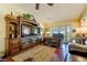Cozy living room features a large entertainment center, a plush recliner, and a sliding door to the patio at 1349 Foxglove Dr, Las Vegas, NV 89142