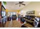 Comfortable living room with plush sofas, a large entertainment center, and an open view of the bright kitchen at 1349 Foxglove Dr, Las Vegas, NV 89142