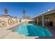 Cool off in this backyard pool with tanning ledge, unique brickwork, and shade at 1349 Foxglove Dr, Las Vegas, NV 89142