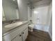 Bathroom featuring a shower-tub combo, vanity, toilet, and wood-look vinyl flooring at 1460 Hialeah Dr # D, Las Vegas, NV 89119