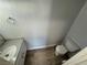 A toilet sits beside a modern sink and vanity in a clean and simple bathroom with light wood flooring at 1460 Hialeah Dr # D, Las Vegas, NV 89119