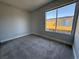 This bedroom is carpeted and has a large window at 1460 Hialeah Dr # D, Las Vegas, NV 89119