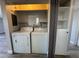 Convenient laundry area features a washer, dryer, and shelving for storage at 1460 Hialeah Dr # D, Las Vegas, NV 89119