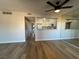 Open-concept living space features wood-look floors, ceiling fan, and a kitchen pass-through at 1460 Hialeah Dr # D, Las Vegas, NV 89119