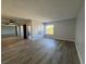 Spacious living room with wood-look floors, a ceiling fan, and a large window at 1460 Hialeah Dr # D, Las Vegas, NV 89119