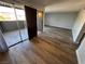 Living room with wood flooring, sliding doors to patio, and an open doorway at 1460 Hialeah Dr # D, Las Vegas, NV 89119