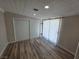 Cozy bedroom features a sliding-door closet and a large window with natural light at 1642 Palma Vista Ave, Las Vegas, NV 89169