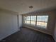 Bright bedroom featuring carpet, closet, and a large window for ample natural light at 1642 Palma Vista Ave, Las Vegas, NV 89169