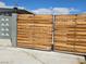 Horizontal wooden gate with black hardware provides stylish curb appeal and privacy at 1642 Palma Vista Ave, Las Vegas, NV 89169