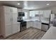Bright kitchen features white cabinets, stainless steel appliances, and a modern countertop at 1642 Palma Vista Ave, Las Vegas, NV 89169