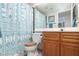 This is a clean bathroom with a wood vanity and a patterned shower curtain at 1701 E Katie Ave # 57, Las Vegas, NV 89119