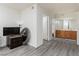 Bright bedroom leading into a bathroom with cabinets featuring wood-look floors and neutral paint at 1701 E Katie Ave # 57, Las Vegas, NV 89119