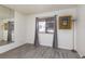 Bright bedroom featuring wood-look floors, a window with gray curtains, and a full-length mirror at 1701 E Katie Ave # 57, Las Vegas, NV 89119