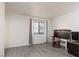 Bedroom featuring wood-look floors, large window, desk with chair, and mounted television at 1701 E Katie Ave # 57, Las Vegas, NV 89119