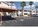 Exterior view of the community featuring covered parking, palm trees, and clearly marked parking at 1701 E Katie Ave # 57, Las Vegas, NV 89119