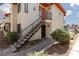 Charming condo featuring an exterior staircase leading to the unit's entrance and desert landscaping at 1701 E Katie Ave # 57, Las Vegas, NV 89119