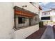 Apartment exterior featuring secure window bars, a well-kept walkway and neat landscaping at 1701 E Katie Ave # 57, Las Vegas, NV 89119