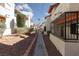Exterior view of well-maintained condo buildings with desert landscaping and walkway at 1701 E Katie Ave # 57, Las Vegas, NV 89119