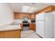 Bright kitchen featuring wood cabinets and stainless steel appliances including a range and microwave at 1701 E Katie Ave # 57, Las Vegas, NV 89119