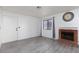 Inviting living room with wood-look flooring, a brick fireplace, and large windows with natural light at 1701 E Katie Ave # 57, Las Vegas, NV 89119