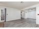 Open living room with wood-look flooring, ceiling fan, and a door leading to the outside at 1701 E Katie Ave # 57, Las Vegas, NV 89119