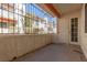 Private patio offering outdoor space with a railing, textured walls, and doorway entrance at 1701 E Katie Ave # 57, Las Vegas, NV 89119