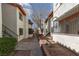 Exterior walkway between apartments, showing well-maintained landscaping and access to upper units at 1701 E Katie Ave # 57, Las Vegas, NV 89119