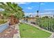 Backyard with artificial turf, rock landscaping, and a white metal fence at 1904 Chapman Dr, Las Vegas, NV 89104