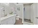 Bright bathroom featuring a spacious vanity, modern toilet, and a glass-enclosed shower with marble-like tiles at 1904 Chapman Dr, Las Vegas, NV 89104