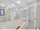 Bright bathroom showcasing a large soaking tub, mirrored wall, and updated fixtures at 1904 Chapman Dr, Las Vegas, NV 89104