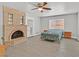 Spacious bedroom featuring a brick fireplace and a ceiling fan for added comfort at 1904 Chapman Dr, Las Vegas, NV 89104
