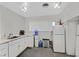 Kitchen featuring white cabinets and a refrigerator at 1904 Chapman Dr, Las Vegas, NV 89104