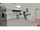 Well-lit kitchen with stainless steel appliances, white cabinets, and a window at 1904 Chapman Dr, Las Vegas, NV 89104